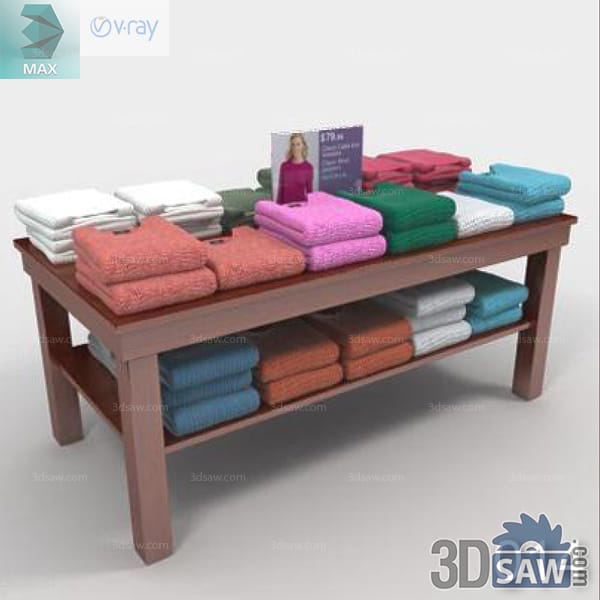 Dark wood retail table stacked with colorful folded knitwear