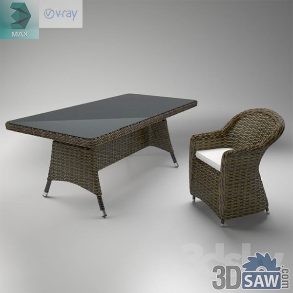 Woven rattan dining table with glass top beside a curved rattan armchair