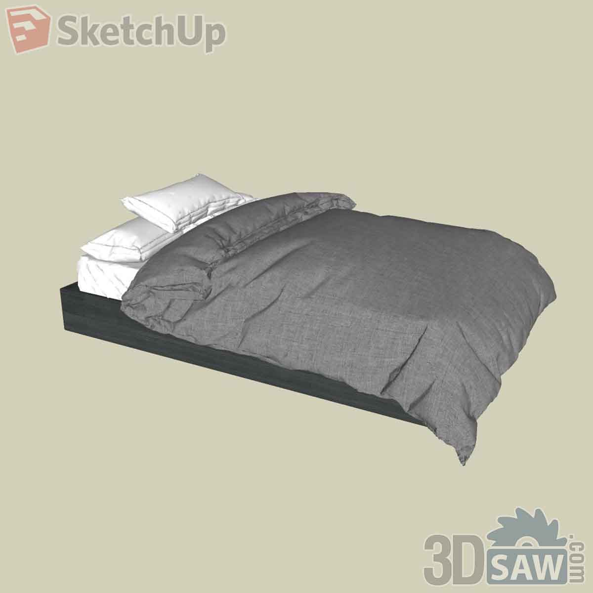 Low dark platform bed with a rumpled grey duvet and two white pillows