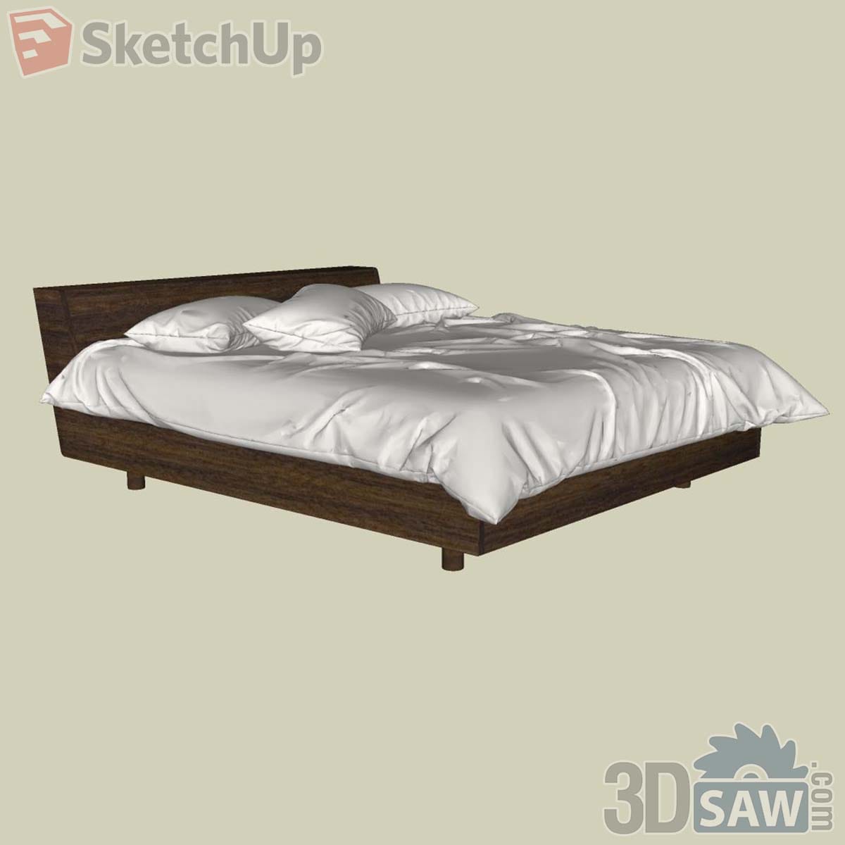Contemporary walnut bed with a full-width low headboard and white duvet and pillows
