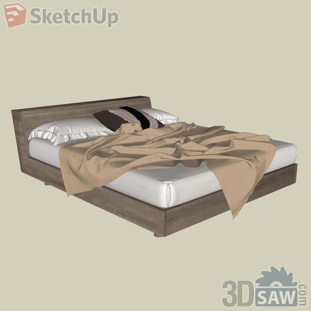 Grey oak platform bed with white sheets, a beige throw and a striped accent cushion