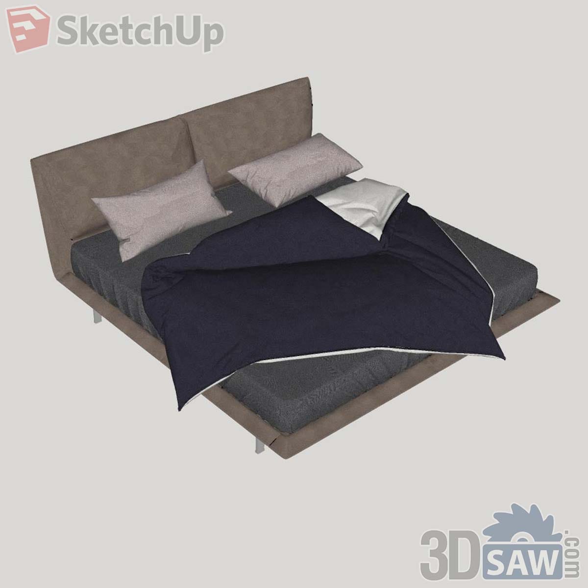 Modern upholstered bed with taupe split headboard, slim metal legs and a navy duvet