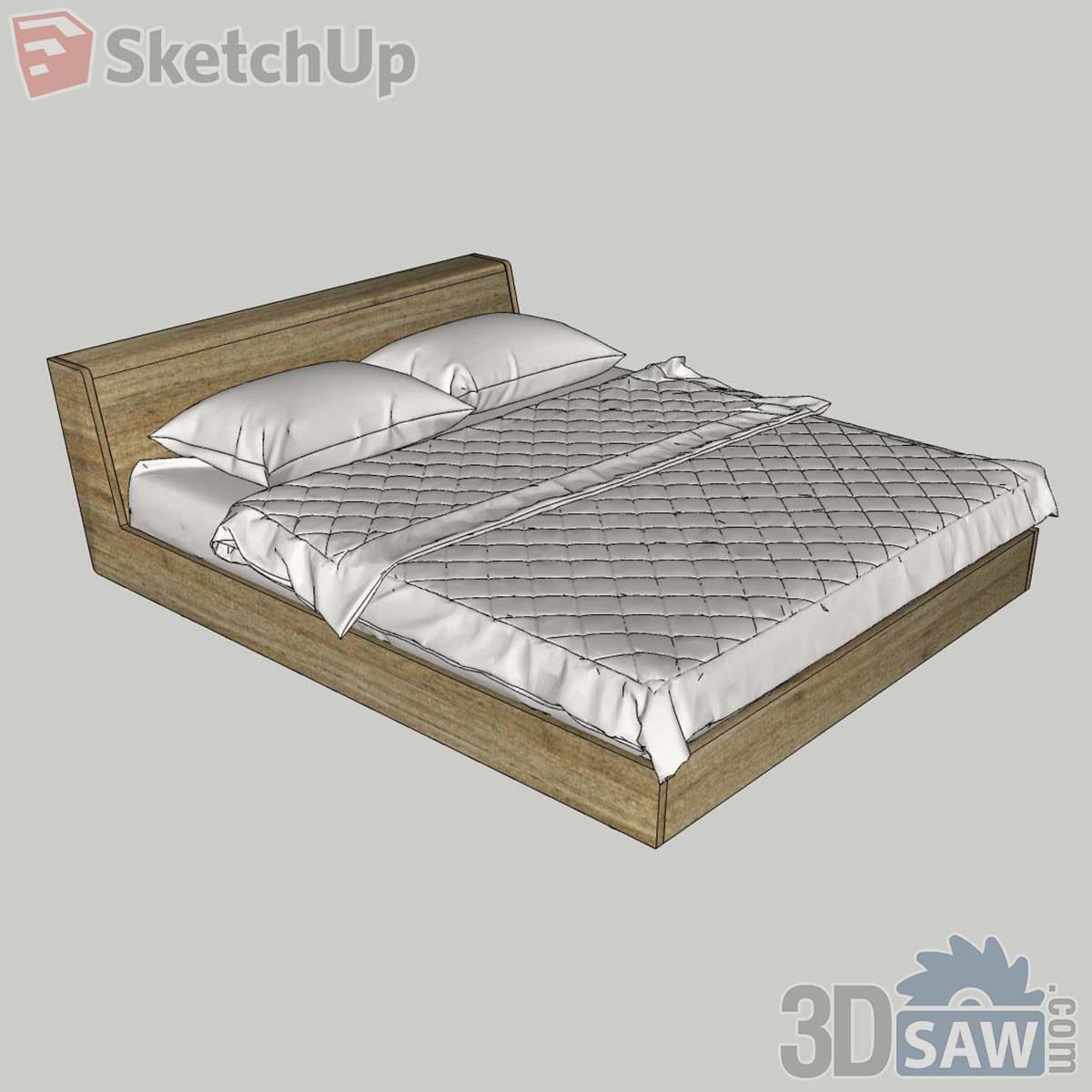 Natural light oak box bed with reclined headboard and a diamond-quilted white coverlet