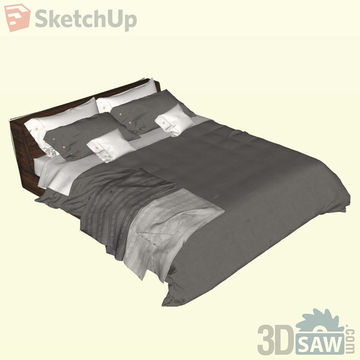 Contemporary bed with charcoal duvet, layered charcoal and white pillows and a striped runner