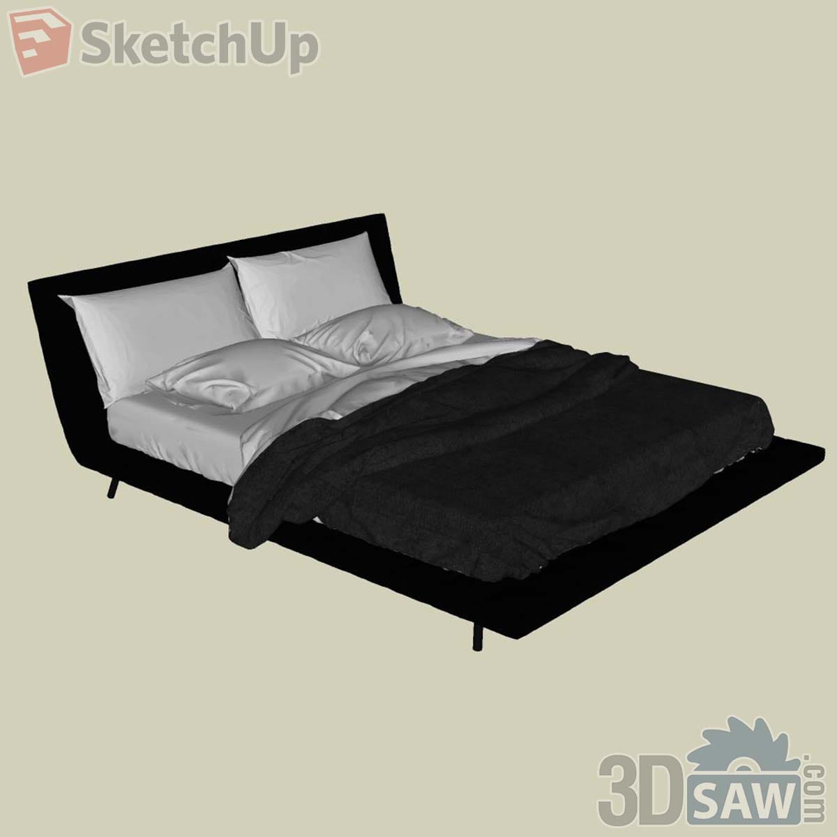 Black upholstered bed with curved headboard, thin metal legs and a black throw over white sheets