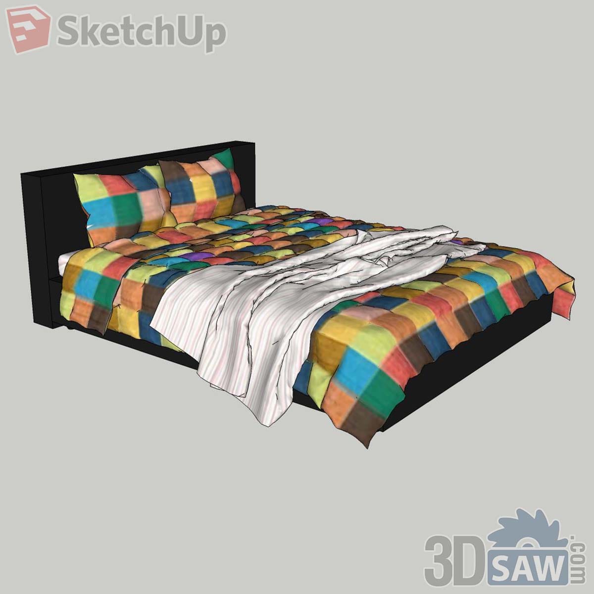 Black bed frame with a colourful patchwork quilt, matching pillows and a striped white sheet