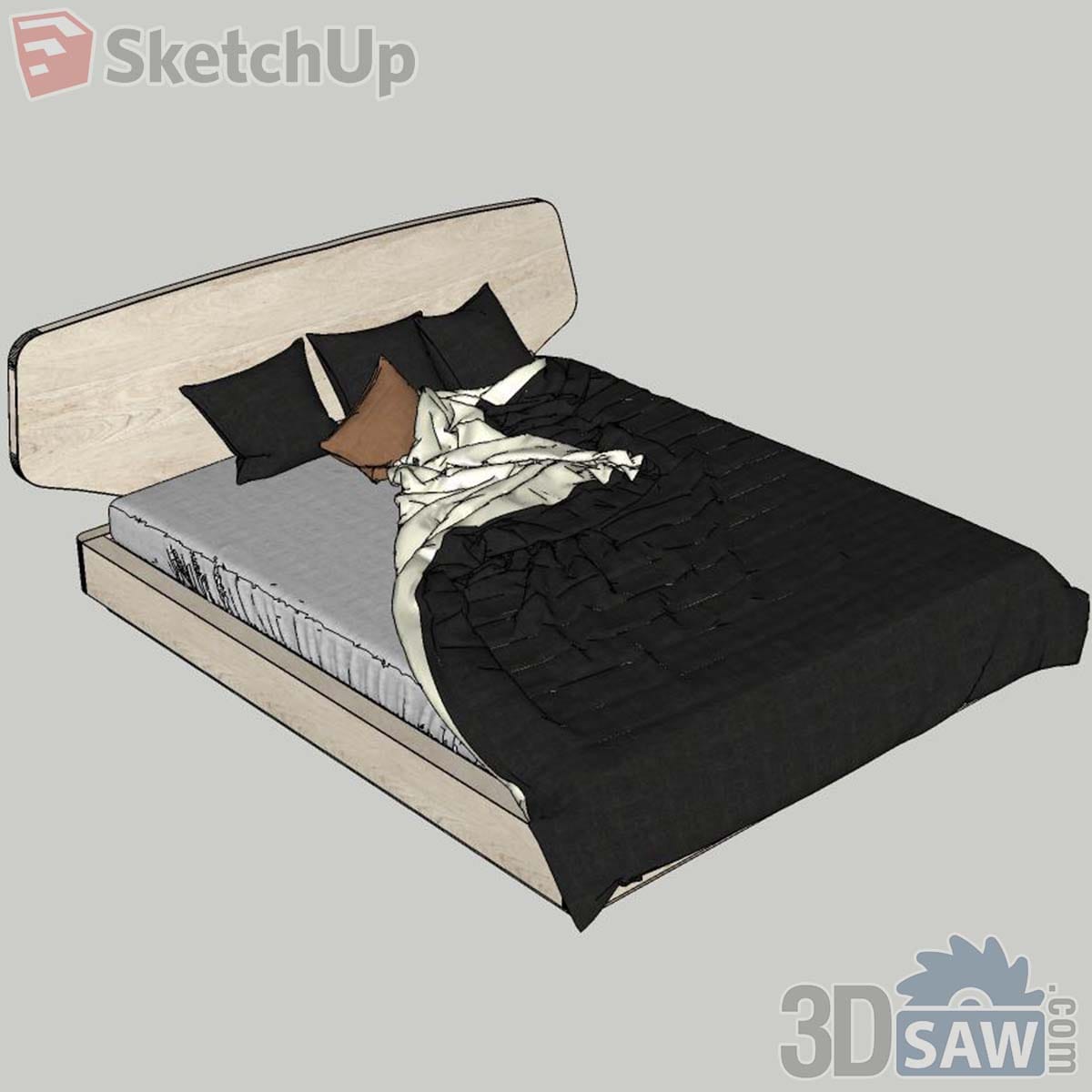 Pale oak bed with rounded headboard, black quilted duvet and black and rust cushions