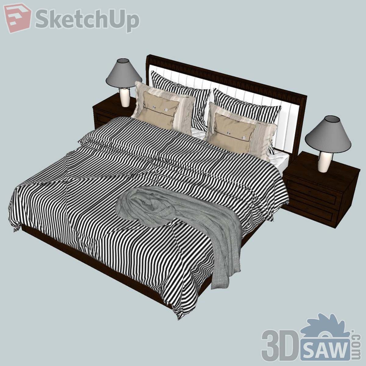 Dark wood bed with black and white striped bedding, drawer nightstands and grey table lamps