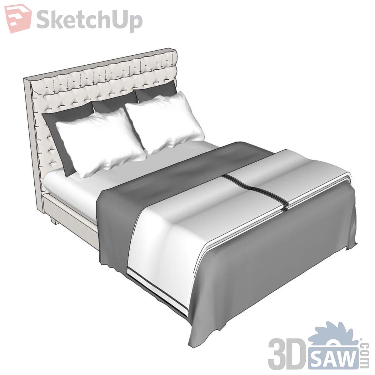 Bed with tall cream button-tufted headboard, white pillows and grey folded runner