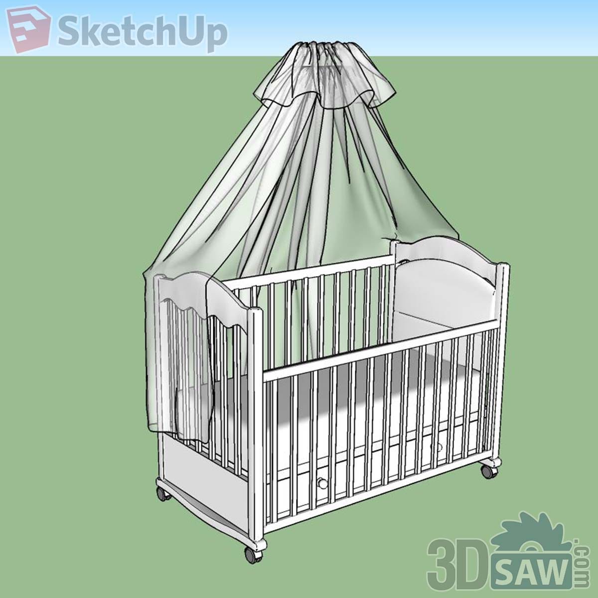 White wooden baby crib on castors with scalloped ends and a sheer green canopy